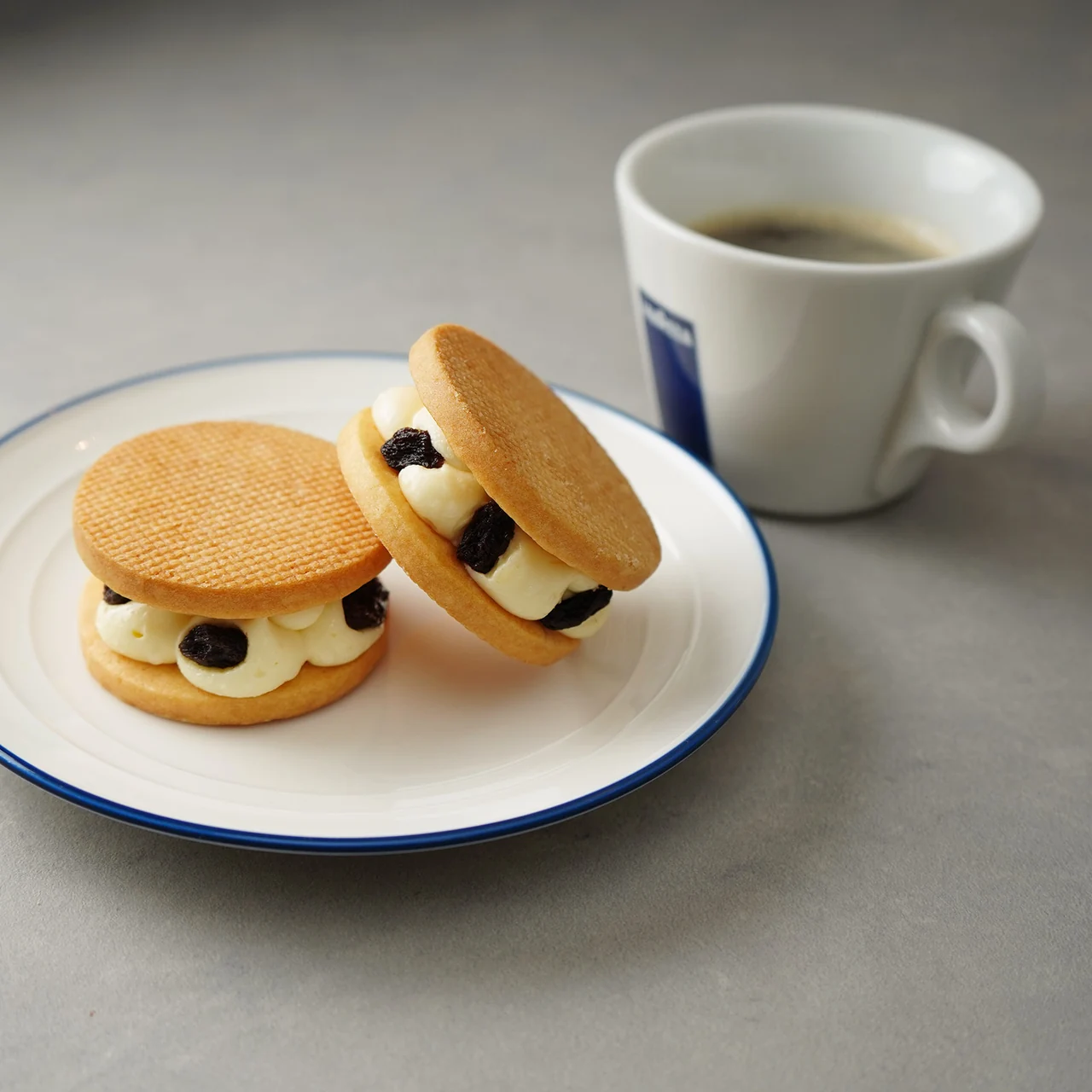コーヒーとお皿に盛りつけたラムレーズンのバターサンド